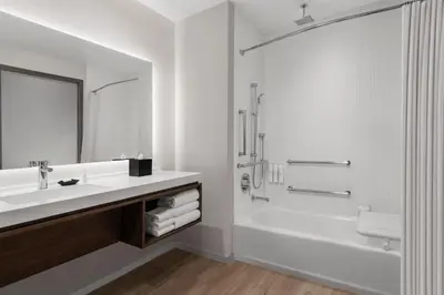 a white bathroom with a sink and a shower at AC Hotel by Marriott Pasadena in Pasadena