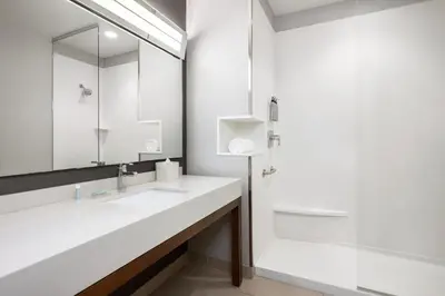 a bathroom with a sink and a mirror at AC Hotel by Marriott Pasadena in Pasadena