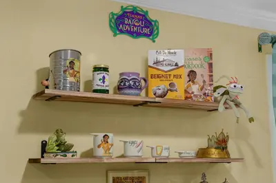 a shelf with toys and books on a wall at Disneyland Oasis by OC Adventure Homes in Cypress