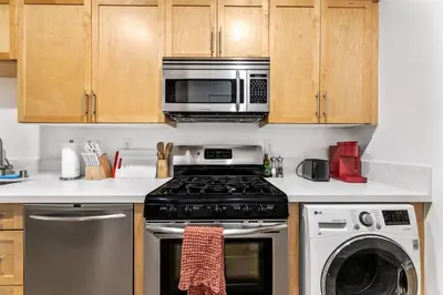 a kitchen with a stove and a microwave at Amazing studio in SM Promenade! Free parking! in Los Angeles