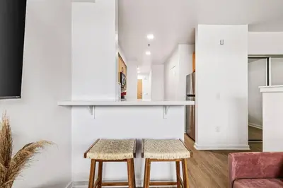 a kitchen with a table and two stools at Amazing studio in SM Promenade! Free parking! in Los Angeles