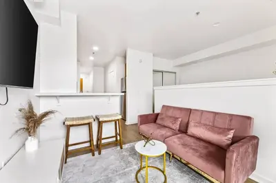 a living room with a couch and a table at Amazing studio in SM Promenade! Free parking! in Los Angeles