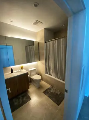 a bathroom with a toilet and a sink and a shower at Elegant Luxury 1 Bedroom studio in Downtown LA in Vernon