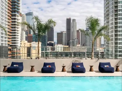 a swimming pool with a city skyline in the background at Elegant Luxury 1 Bedroom studio in Downtown LA in Vernon