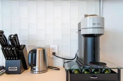 a coffee maker sitting on top of a counter with cupcakes at The Pearl Coast - Rooftop Pool, Gym Luxurious 2BR Santa Monica in Los Angeles