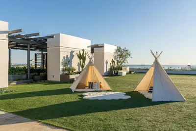 two tents on the grass in front of a house at The Pearl Coast - Rooftop Pool, Gym Luxurious 2BR Santa Monica in Los Angeles