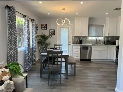 a kitchen with a table and a dining room at Adorable 2BR-2BA House with EV & Free Parking and Family Friendly in Los Angeles in Los Angeles