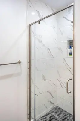 a shower with a glass door in a bathroom at Adorable 2BR-2BA House with EV & Free Parking and Family Friendly in Los Angeles in Los Angeles