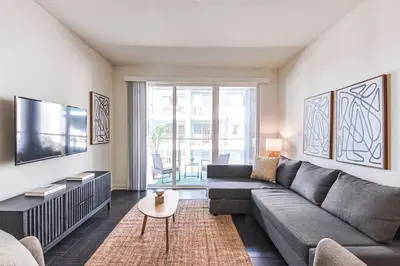 a living room with a couch and a tv at Spacious 2BD 2BA with Huge Balcony, Near Venice Beach & Fun! in Marina del Rey