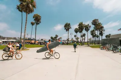 a group of people riding bikes with a surfboard at Spacious 2BD 2BA with Huge Balcony, Near Venice Beach & Fun! in Marina del Rey