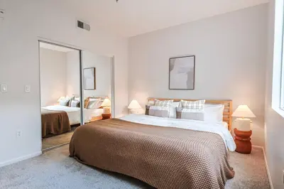 a bedroom with a large bed and a large mirror at Well-Located 3BR Near SoFi Stadium & LAX in Los Angeles