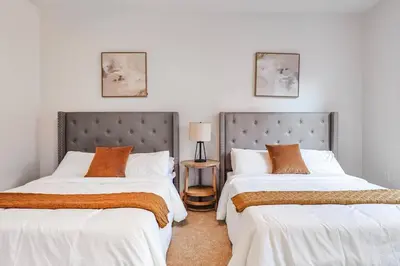 two beds sitting next to each other in a bedroom at Well-Located 3BR Near SoFi Stadium & LAX in Los Angeles
