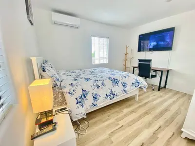a bedroom with a bed and a desk in it at Sunset room only 1 guest near DTLA in San Gabriel