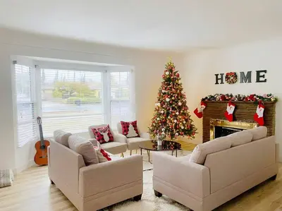 a living room with a christmas tree in front of a fireplace at Sunset room only 1 guest near DTLA in San Gabriel