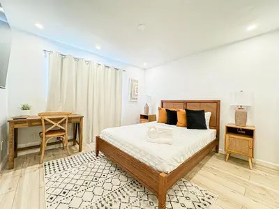 a bedroom with a bed and a desk and a table at Boho-Chic 1BR-1BA Oasis near Hollywood -BRBEV13 in Los Angeles