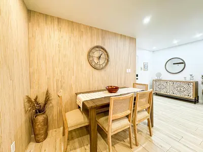 a dining room with a table and chairs and a clock at Boho-Chic 1BR-1BA Oasis near Hollywood -BRBEV13 in Los Angeles