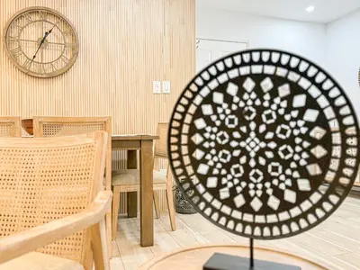 a room with a clock and a table and chairs at Boho-Chic 1BR-1BA Oasis near Hollywood -BRBEV13 in Los Angeles