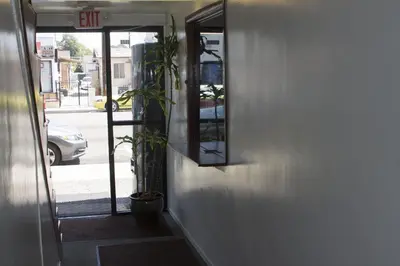 a door to a building with a plant next to it at Lido Hotel in Huntington Park