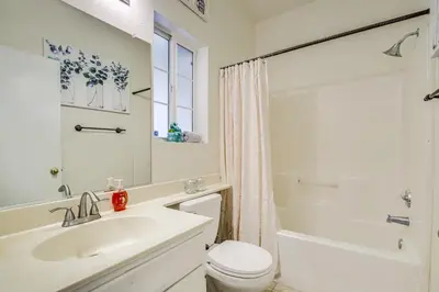 a white bathroom with a sink and a toilet at Family-Friendly Home with Fenced Yard in Victorville in Victorville