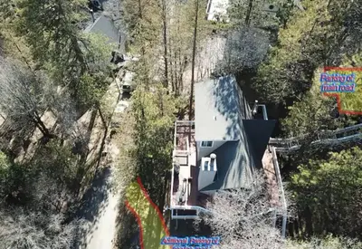 an aerial view of a house on a mountain at Whispering Pines A-Frame, Pool Table, 2 Patios! in Lake Arrowhead