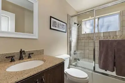 a bathroom with a sink and a toilet and a shower at Whispering Pines A-Frame, Pool Table, 2 Patios! in Lake Arrowhead