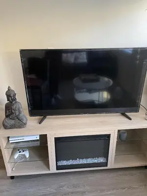 a large flat screen tv on a wooden entertainment center at Cozy spot in Koreatown in Los Angeles