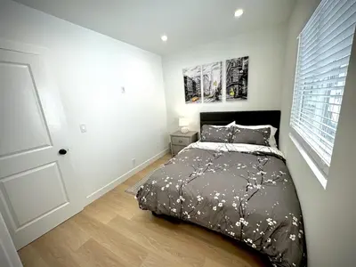 a bedroom with a bed with a black comforter at RP415B - Inviting 1-Bedroom Haven in Captivating Burbank in Burbank