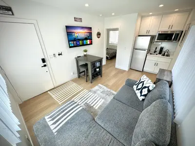 a living room with a couch and a kitchen at RP415B - Inviting 1-Bedroom Haven in Captivating Burbank in Burbank