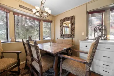 a dining room with a wooden table and chairs at Smo Haus- Located in the quiet area of Big Bear City, with mountain views. in Big Bear City