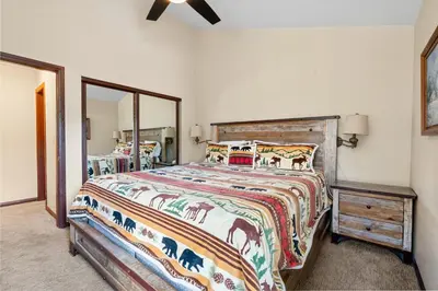 a bedroom with a bed with a horse blanket at Shores Lakefront Condo - Walk to Village, Lake Views, Deck with BBQ in Big Bear Lake