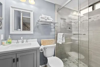 a bathroom with a shower and a toilet and a sink at Shores Lakefront Condo - Walk to Village, Lake Views, Deck with BBQ in Big Bear Lake