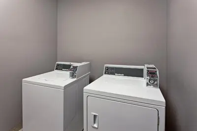 a laundry room with a washer and dryer at Holiday Inn Express & Suites Anaheim Resort Area by IHG in Anaheim