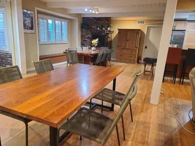 a dining room with a wooden table and chairs at Westside Retreat w Yard, Grill, Hot Tub, Near Sofi Stadium, LAX, and the Beach in Los Angeles