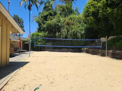 a volleyball net in the middle of a beach at Westside Retreat w Yard, Grill, Hot Tub, Near Sofi Stadium, LAX, and the Beach in Los Angeles
