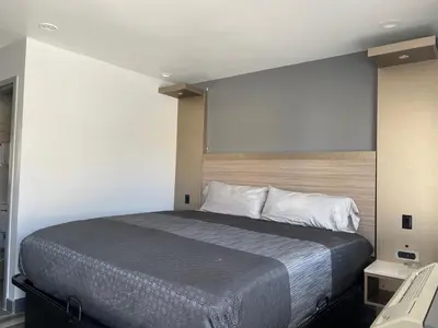 a bedroom with a large bed in a room at Bronco Motel South Central in Los Angeles
