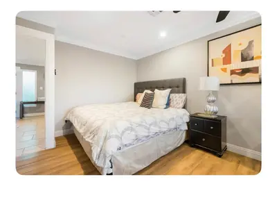 a bedroom with a bed and a table with a lamp at LA Million dollar VIEW super spacious 5 bedroom home in Hacienda Heights