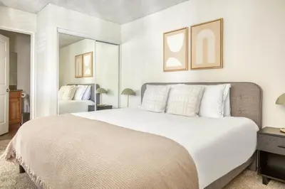 a bedroom with a large white bed and a mirror at Blueground N Hollywood Gym Pool nr shops LAX-515 in Los Angeles