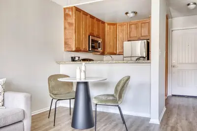 a kitchen with a table and chairs in a living room at Blueground N Hollywood Gym Pool nr shops LAX-515 in Los Angeles