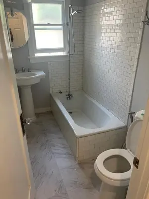 a bathroom with a tub and a toilet and a sink at Hancock weho in Los Angeles