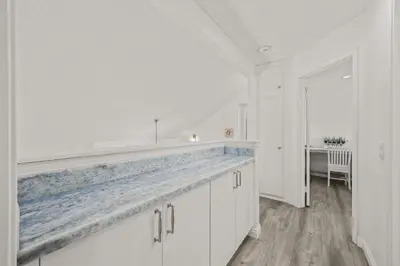 a kitchen with white cabinets and a blue counter top at Newly Remodel Luxury Home with Hotel-Like Amenity in Rowland