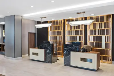 a lobby with wooden shelves and a desk at La Quinta Inn & Suites by Wyndham La Habra in La Habra