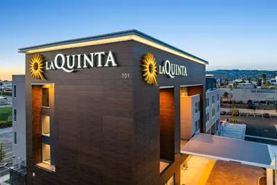 a building with a sign on the side of it at La Quinta Inn & Suites by Wyndham La Habra in La Habra