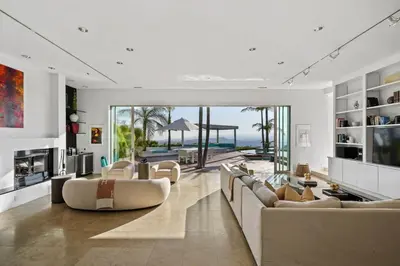 a living room with couches and a view of the ocean at Crest Estate by Stay Awhile Villas in Los Angeles