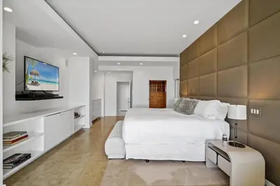 a bedroom with a large white bed and a tv at Crest Estate by Stay Awhile Villas in Los Angeles