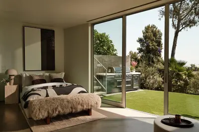 a bedroom with a bed and a large window at Eterne by Stay Awhile Villas in Los Angeles
