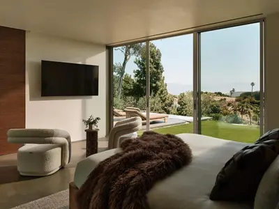 a bedroom with a large bed and a large window at Eterne by Stay Awhile Villas in Los Angeles