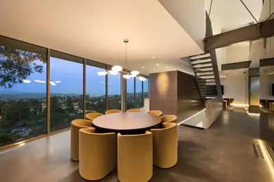 a dining room with a circular table and chairs at Eterne by Stay Awhile Villas in Los Angeles