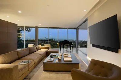 a living room with a couch and a television and a piano at Eterne by Stay Awhile Villas in Los Angeles