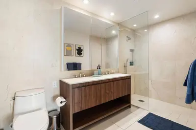 a bathroom with a toilet and a sink and a shower at The Rose Quartz - Rooftop Pool, Gym Glamorous Santa Monica 2BR in Los Angeles
