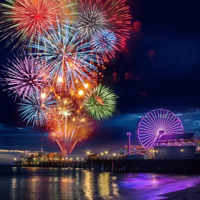 a fireworks display with a ferris wheel in the background at The Rose Quartz - Rooftop Pool, Gym Glamorous Santa Monica 2BR in Los Angeles